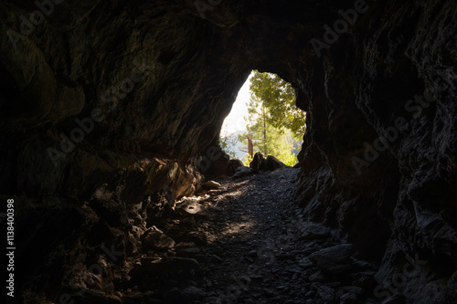View of Steven's Trail cave entrance from inside the cave with light shining in, Colfax, California