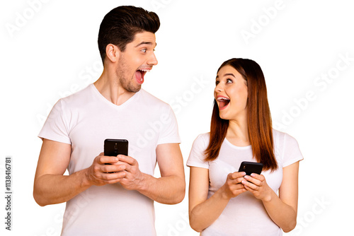 Portrait of his he her she two nice attractive lovely stylish trendy cheerful cheery positive people using new cool gadget device wow isolated over vivid shine bright yellow background photo