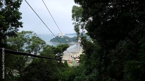 Cable car of Sao Vicente - SP, Brazil. Landscape going down the cable car with the view to Itarare Beach and Porchat Island. Coast of Sao Paulo state.