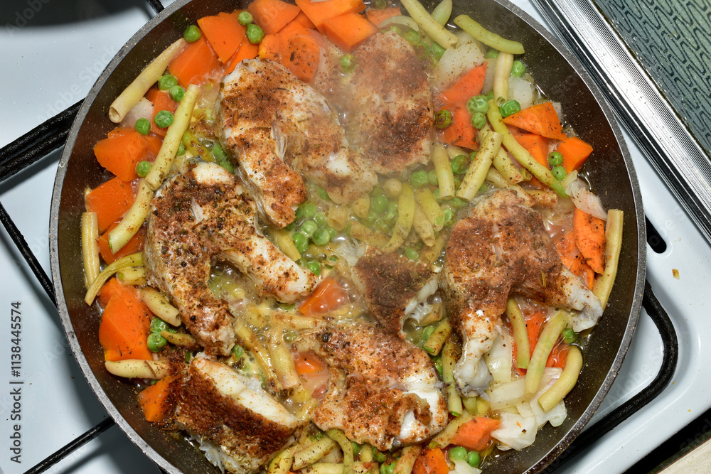 View of cod fish being fried in a frying pan. Top view. View of cod fish being fried in a frying pan. Top view.