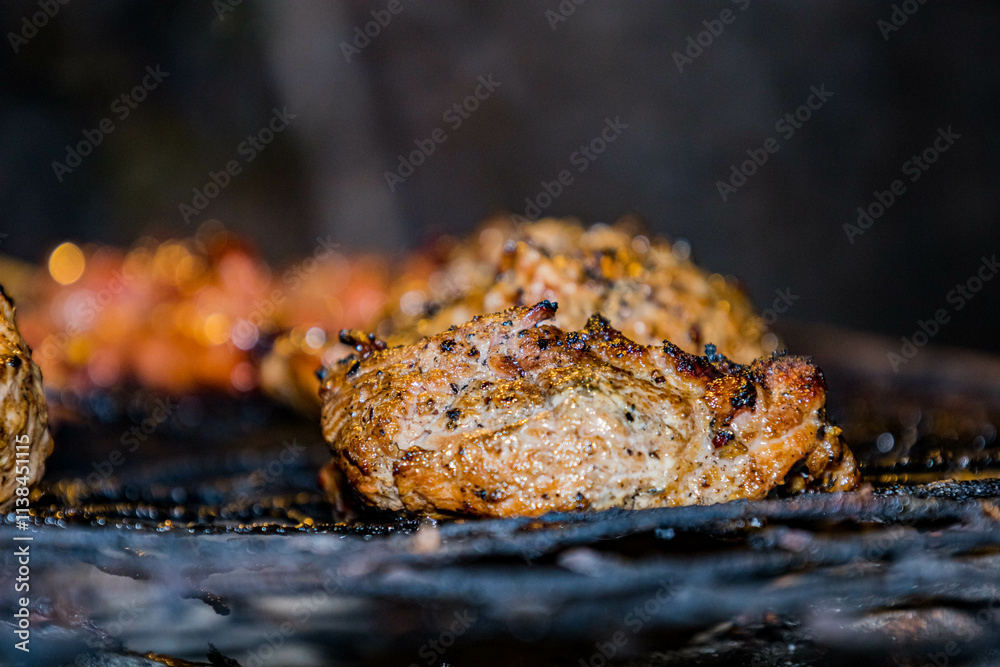 Grilled chicken wings and shish kebab on the barbecue with smoke and fire Grilled chicken wings and shish kebab on the barbecue with smoke and fire