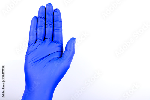 hand wearing a blue nitrile glove against a plain white background. 