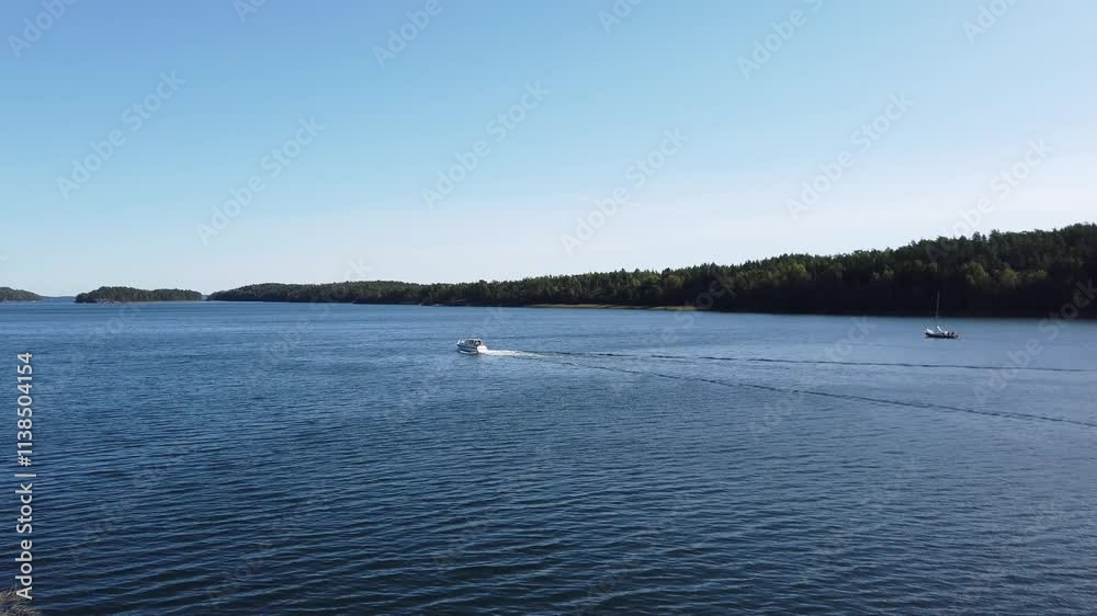 Boats moving in a bay in Sweden during the summer. Boats moving in a bay in Sweden during the summer.