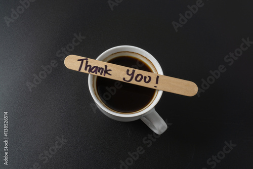 A cup of coffee with a word Thank You on black background