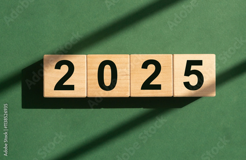 2025 new year, text numbers on wooden cube blocks on eco green background. photo