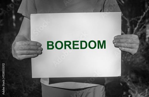 Boredom word, text on paper, boring life, psychology concept.