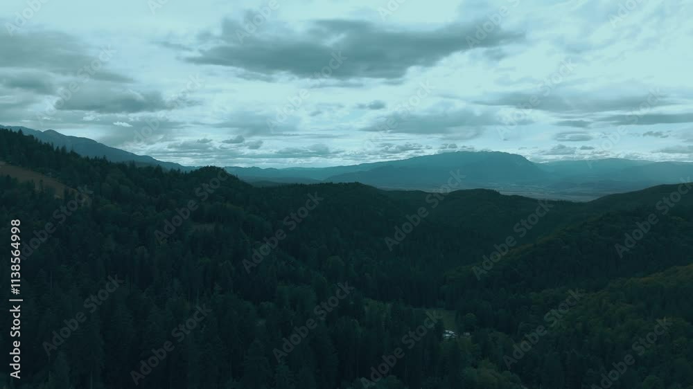 Stunning aerial shot capturing lush mountains and cloudy skies, evoking tranquility and nature's beauty. Stunning aerial shot capturing lush mountains and cloudy skies, evoking tranquility and nature's beauty.