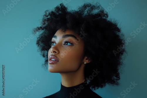 Stunning Portrait of a Young Woman with Natural Curly Hair Against a Soft Blue Background