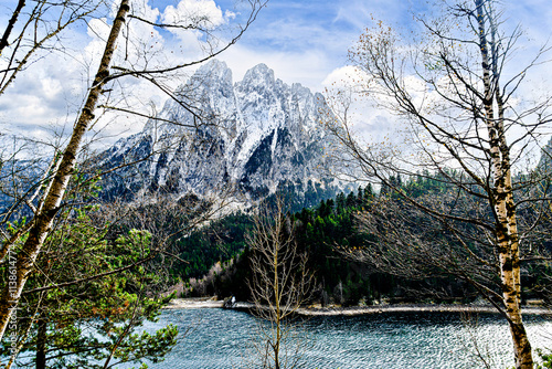 Image of Sant Maurici Lake with snow-capped mountains, in the Aigües Tortes National Park, in the Lleida Pyrenees, Catalonia, Spain photo