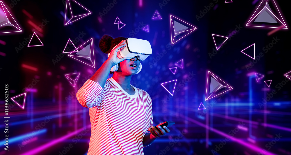 Girl looking around at geometric shape floating in metaverse. Happy teenager or gamer using VR headset and augmented reality technology accessing virtual world. Technology innovation. Ingenuity. Girl looking around at geometric shape floating in metaverse. Happy teenager or gamer using VR headset and augmented reality technology accessing virtual world. Technology innovation. Ingenuity.
