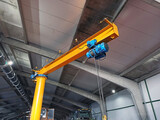 Indoor jib crane for repairing agricultural machinery.