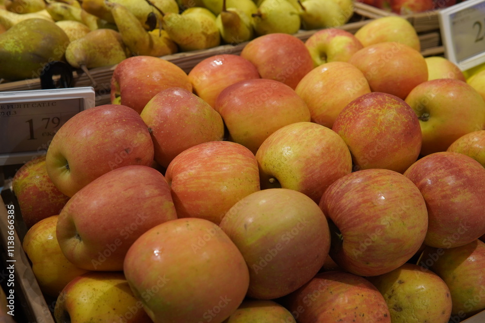 Fresh apples of different varieties. Red, green and yellow fruits are neatly laid out on the store counter, creating a bright and appetizing composition. Fresh apples of different varieties. Red, green and yellow fruits are neatly laid out on the store counter, creating a bright and appetizing composition.