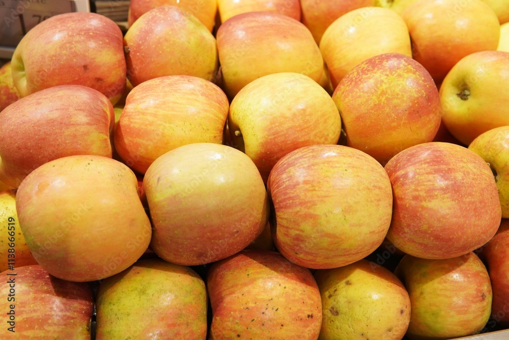 Fresh apples of different varieties. Red, green and yellow fruits are neatly laid out on the store counter, creating a bright and appetizing composition. Fresh apples of different varieties. Red, green and yellow fruits are neatly laid out on the store counter, creating a bright and appetizing composition.