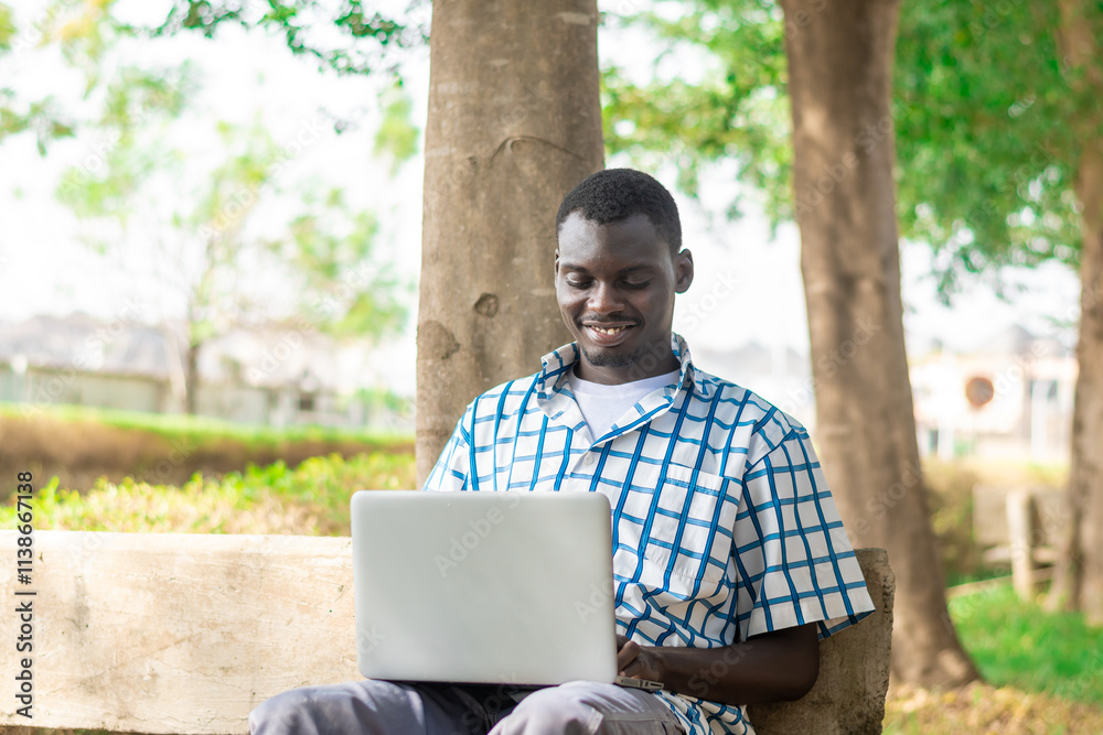 young African American man making use on laptop computer. young African American man making use on laptop computer.