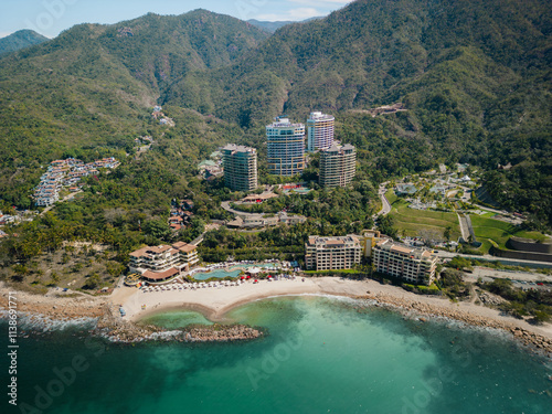 Aerial view of Hotel Mousai Puerto Vallarta Mexico above perfectly blue turquoise ocean water.