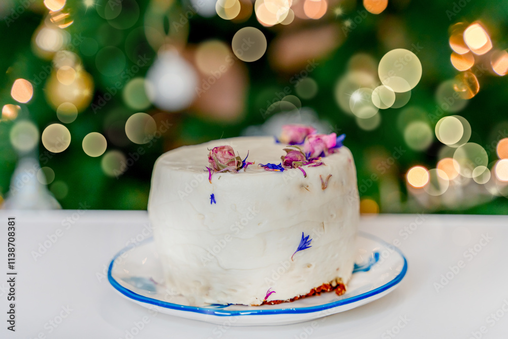 A cake on the background of a Christmas tree, a festive atmosphere of the new year A cake on the background of a Christmas tree, a festive atmosphere of the new year