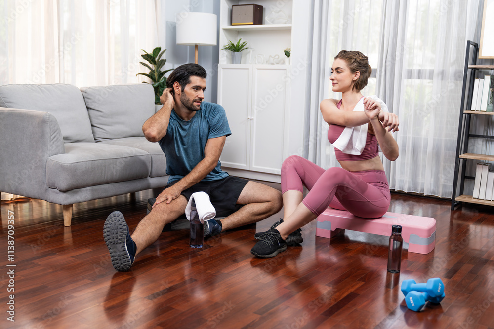 Obraz premium Athletic body and sporty young couple or workout buddy in sportswear warmup or resting after finishing in home workout exercise at gaiety home exercise and healthy lifestyle concept.