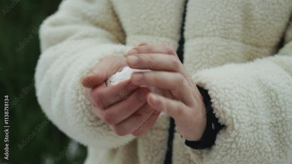 A man in a white fur coat makes snowballs.
The guy plays snowballs.
A man makes snowballs outside in winter.
Wet snow in a man's hands A man in a white fur coat makes snowballs.
The guy plays snowballs.
A man makes snowballs outside in winter.
Wet snow in a man's hands