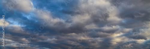 white clouds and dark winter clouds in the blue sky