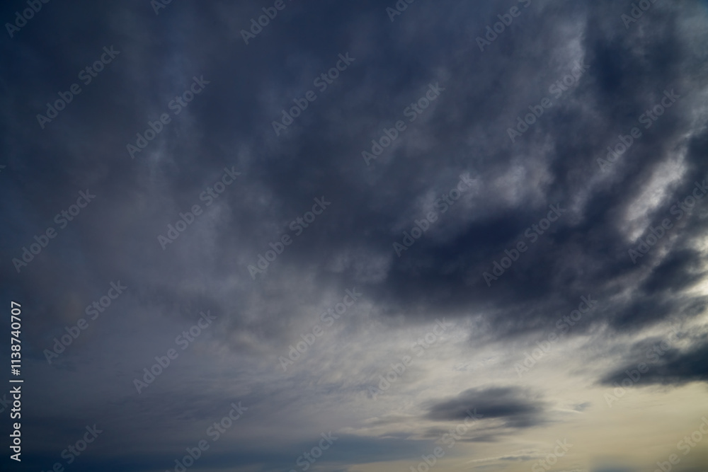 Dark gray-blue clouds cover the sky to the horizon, an impending storm, weather change, winter sky. Dark gray-blue clouds cover the sky to the horizon, an impending storm, weather change, winter sky.