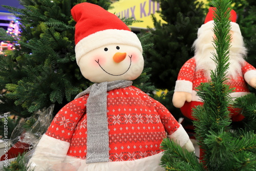 Christmas winter shop 2025, Beautiful funny snowmen in red hats. Favorite New Year s toys and decorations in store. photo