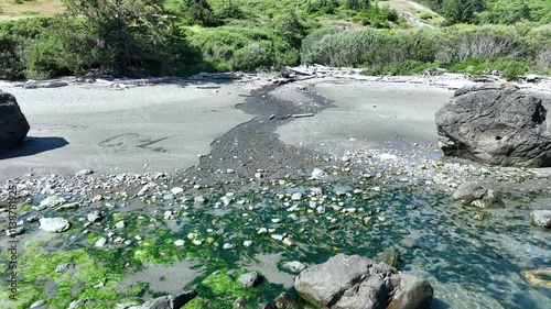 A river flows in to the ocean on the Oregon coast.