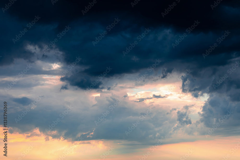 Dramatic pre-storm sky with orange hues blending into dark blue clouds. Atmospheric scene before storm Dramatic pre-storm sky with orange hues blending into dark blue clouds. Atmospheric scene before storm