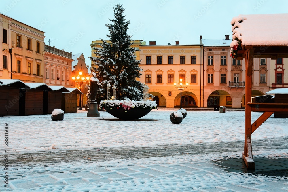 Snow-covered square with sales stands before Christmas at dawn. Novy Jicin. Czech Republic.