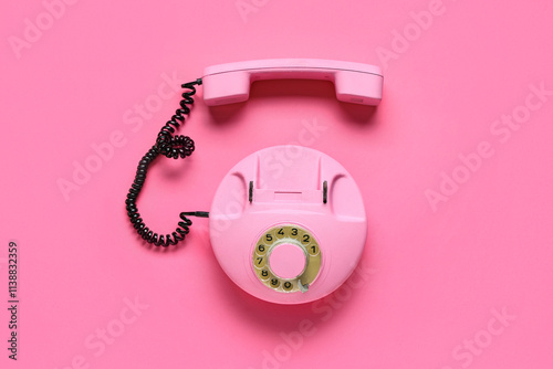 Retro telephone on pink bac...