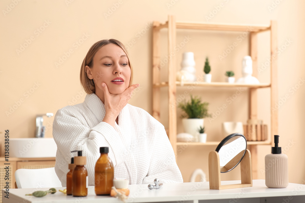 Woman doing face building exercise in bathroom Woman doing face building exercise in bathroom