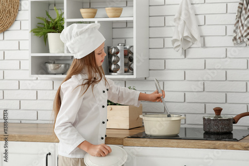 Young girl chef in white un...