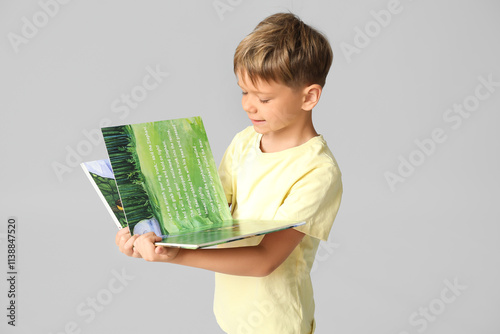 Cute little boy turning pag...