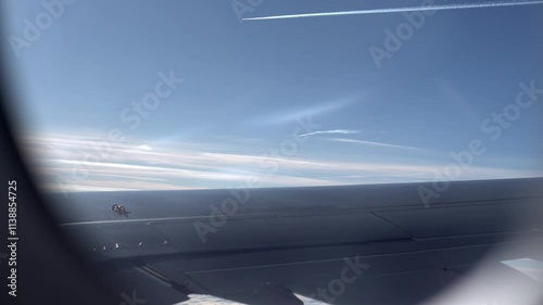 Top bird eye View from passenger porthole of beautiful landscape Flying airplane engine wing of plane fly on sunny cloudy day in winter. Transport, tourism, travel, flight, holidays vacation concept.