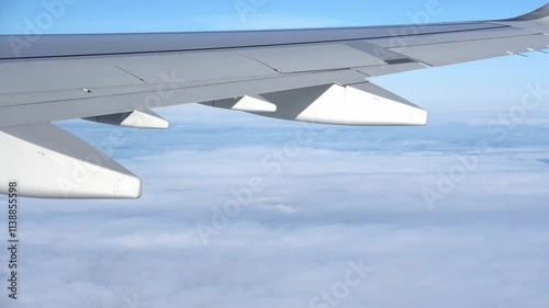 Top bird eye View from passenger porthole of beautiful landscape Flying airplane engine wing of plane fly on sunny cloudy day in winter. Transport, tourism, travel, flight, holidays vacation concept.