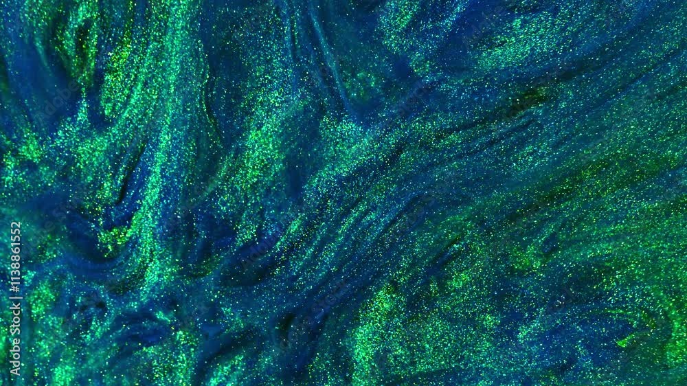 A video featuring shimmering particles and swirling blue and green liquids, creating an abstract, dynamic visual effect. The colors blend in fluid motion, evoking a sense of movement and depth. A video featuring shimmering particles and swirling blue and green liquids, creating an abstract, dynamic visual effect. The colors blend in fluid motion, evoking a sense of movement and depth.