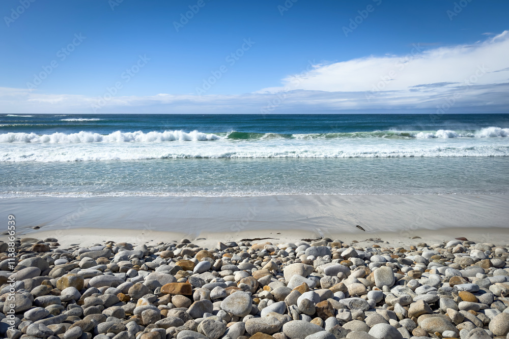 Scenic view of Moss Beach with big round stones along 17-Mile-Drive, Del Monte Forest, California, USA against blue sky with clouds