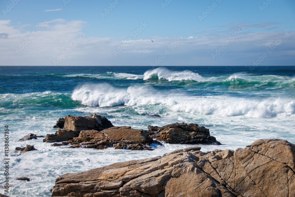 Scenic view of Pacific Ocean waves at the coast seen from Spanish Bay Vista Point, Del Monte Forest, California, USA against blue sky with clouds