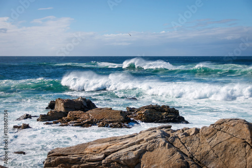 Obraz na płótnie Scenic view of Pacific Ocean waves at the coast seen from Spanish Bay Vista Point, Del Monte Forest, California, USA against blue sky with clouds w salonie