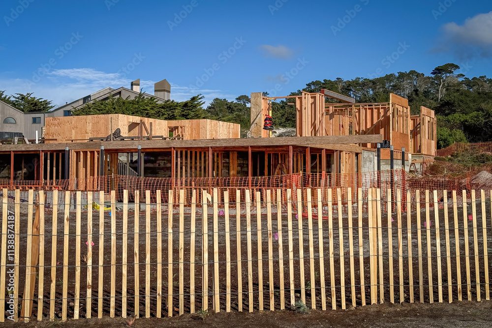 A residential house in the USA under construction against blue sky