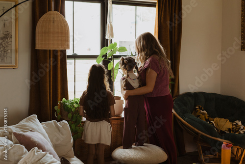 Mother and Children Enjoying a Sunlit Corner of Their Cozy Home, Surrounded by Lush Indoor Plants and Warm Bohemian Decor