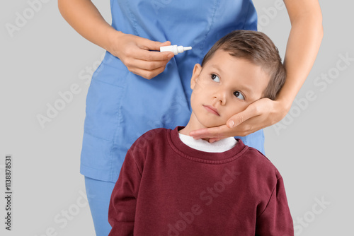Female doctor putting drops...