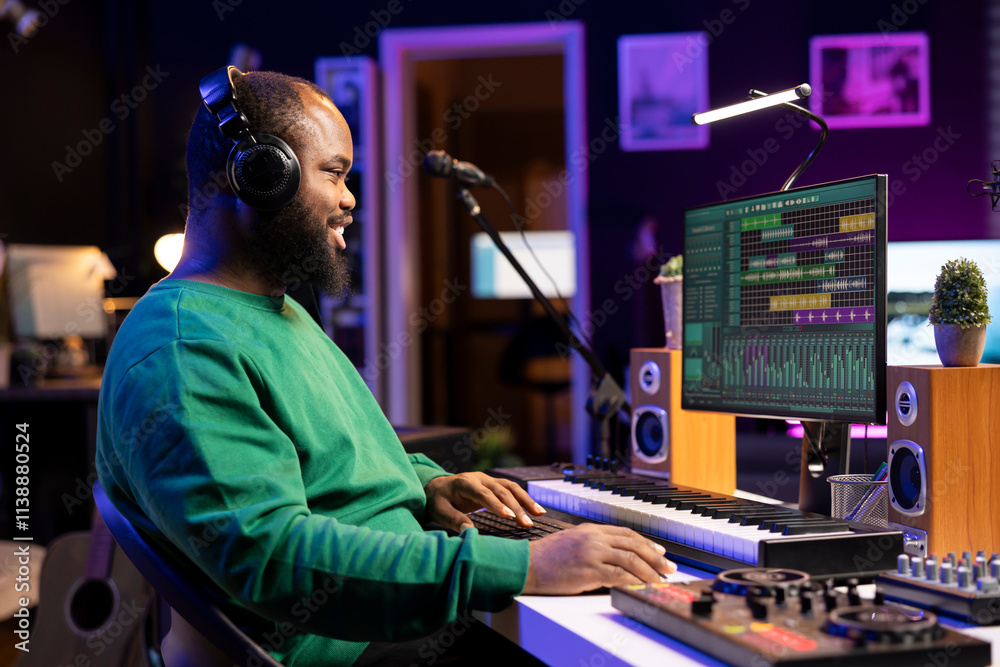 Music producer editing old audio recordings on professional software, operating on mixing console and stereo gear. Sound engineer producing new songs with acoustical tunes in home studio. Music producer editing old audio recordings on professional software, operating on mixing console and stereo gear. Sound engineer producing new songs with acoustical tunes in home studio.