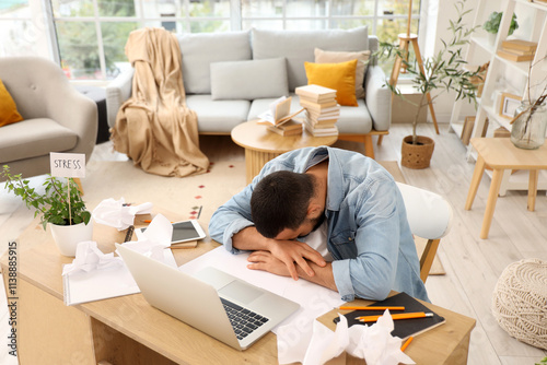 Stressed young man working ...