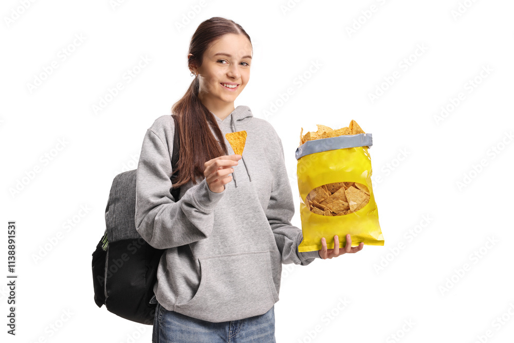 Teenage female student eating crisps and smiling Teenage female student eating crisps and smiling