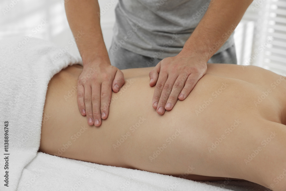 Massage therapist working with patient in clinic, closeup Massage therapist working with patient in clinic, closeup