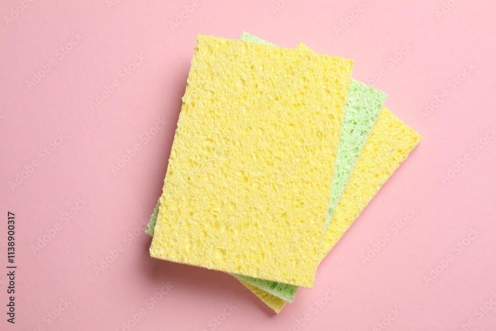 Soft sponges on pink background, top view Soft sponges on pink background, top view