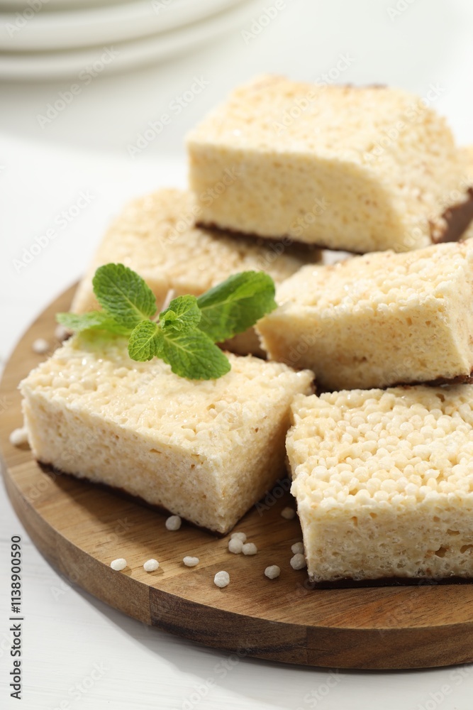 Delicious puffed rice bars and mint on white wooden table, closeup Delicious puffed rice bars and mint on white wooden table, closeup