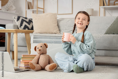 Little girl with tea cup an...