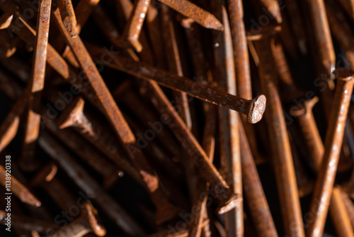 Rusty iron nails piled up in a disorderly fashion