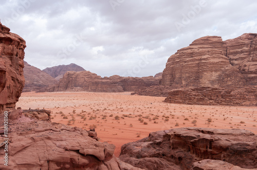 A desert landscape with a rocky outcropping in the foreground